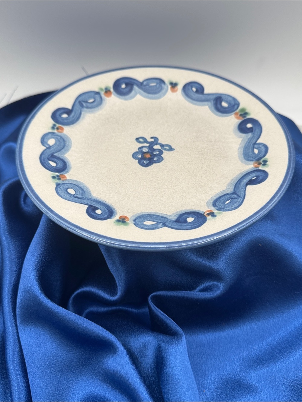 M.A. Hadley Pottery plates; "Bluette" pattern, a signature pink and blue flower